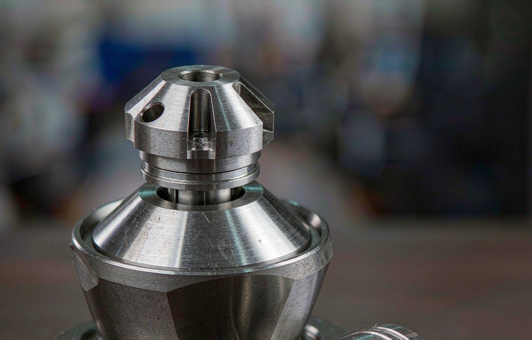 Aluminium extrusion dies, mandrels and engineering drawings laid out on a workbench